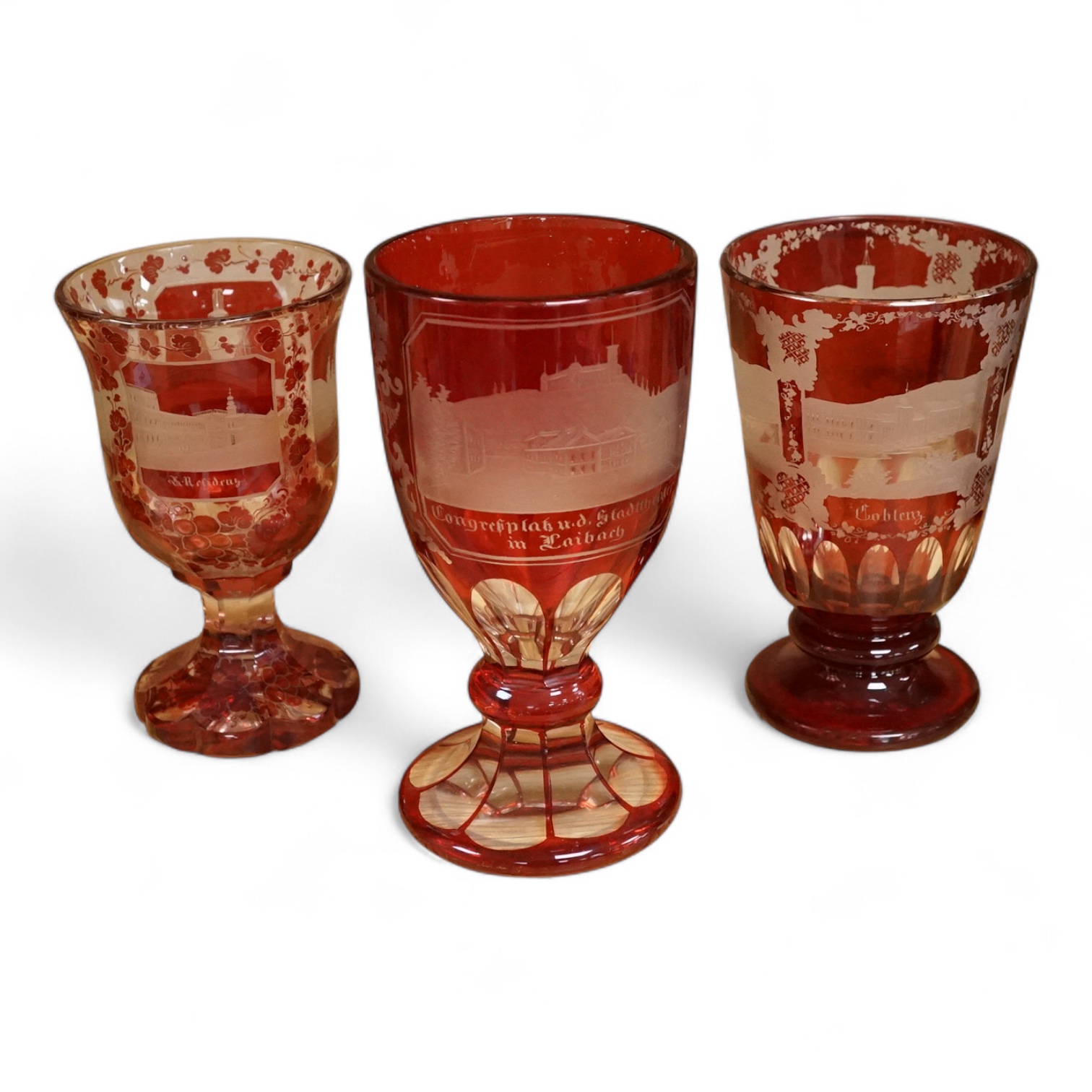 Three Bohemian topographical engraved ruby flashed spa glasses, late 19th century, largest 16cm high